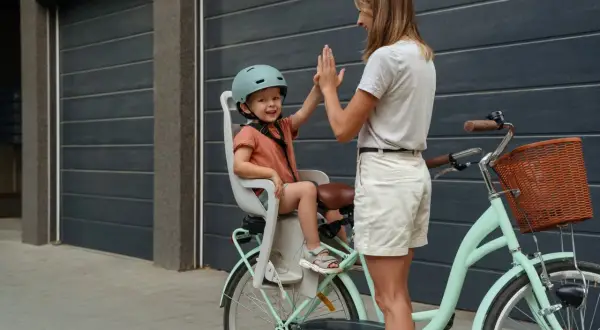 Mama i dziecko dają sobie piątkę przed rowerową wycieczką. To idealny sposób na spędzenie 5 dni urlopu opiekuńczego.