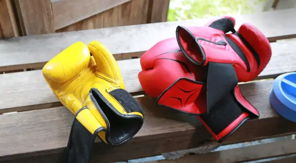 Yellow and red boxing gloves ready for a sparing sport session.