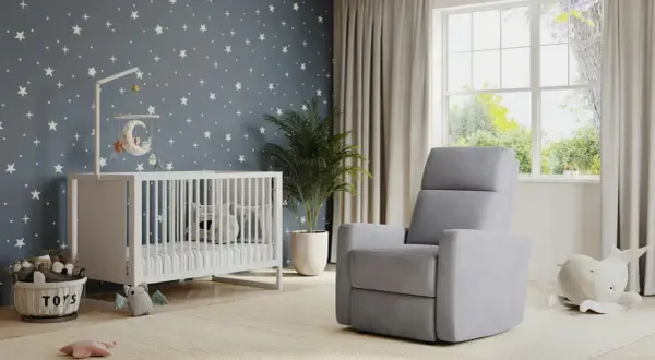 A modern nursery idea with a starry wallpaper, white crib, plush toys, and a comfy grey recliner.