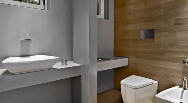 Bagno moderno con lavabo bianco, WC squadrato e pannello di scarico traslato. Problemi di design?