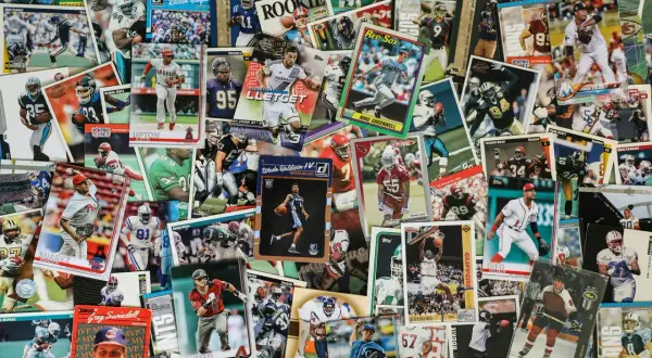 A vibrant collage of sports trading cards, showcasing baseball, basketball, and football players. This collection hints at the world of art consignment, where such memorabilia finds new owners.