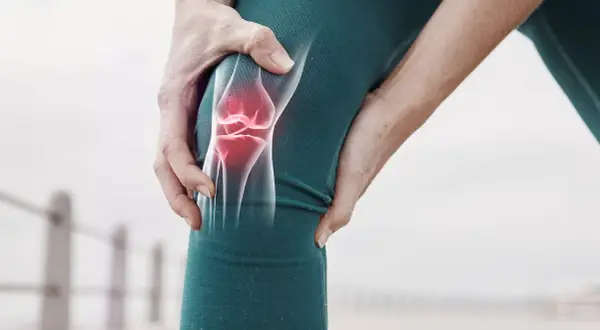 Schmerzendes Knie mit leuchtend rotem Meniskus, der auf eine mögliche Meniskus-OP hinweist.