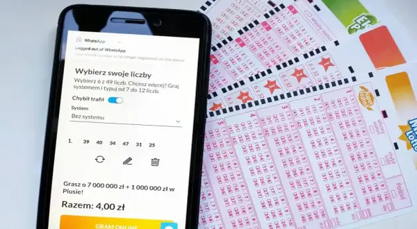 Telefon z aplikacją do gry w Lotto obok kuponów. Dowiedz się, jak zrezygnować z automatycznego odnawiania subskrypcji lotto online.