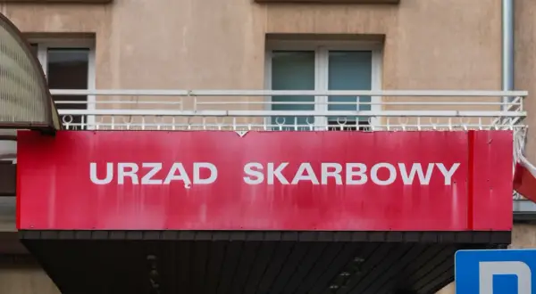 Czerwony szyld "Urząd Skarbowy" nad wejściem. Zastanawiasz się, jakie pytania zada urząd skarbowy po wpłynięciu milionów z zagranicznej loterii?