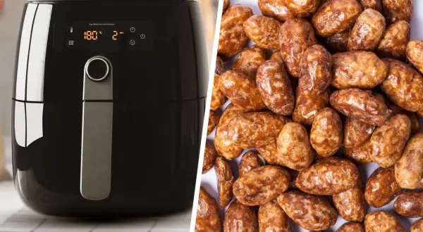 Schwarzer Airfryer neben einem Haufen glänzender, karamellisierter gebrannter Mandeln. Perfekt für süße Snacks!