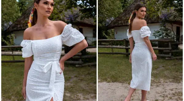 Kobieta w białej, ażurowej sukience z odkrytymi ramionami, w stylu, który przypomina, jak wyglądają hiszpanki.