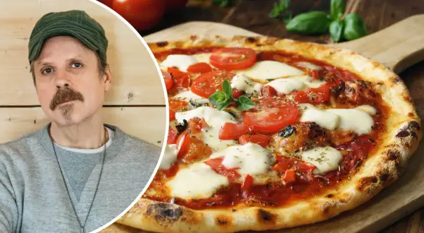 Jonas Cramby njuter av en utsökt pizza med tomater och mozzarella.