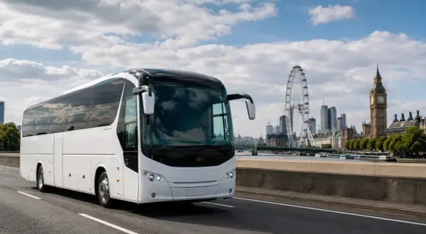 Biały autokar do Londynu jedzie w stronę miasta z Big Benem i London Eye w tle.