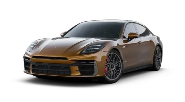 Złoty Porsche Panamera, luksusowy sedan sportowy, prezentuje swoje eleganckie linie i moc.