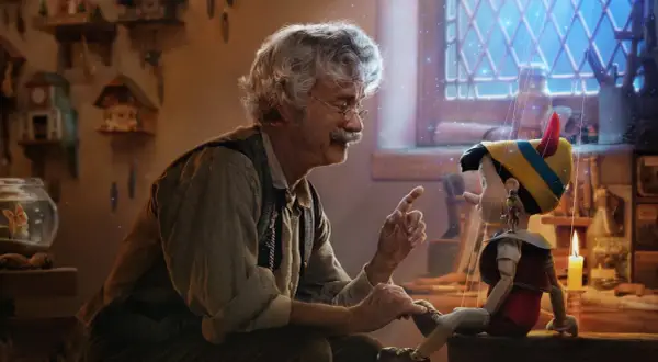 Gepetto pratar med Pinocchio, en docka som ser ut att vara från klassiska familjefilmer. En magisk stämning med gnistrande ljus.