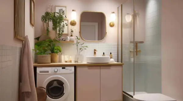 Ein helles Badezimmer mit Waschmaschine, Waschbecken, Spiegel und Dusche. Pflanzen und Dekoration sorgen für Ordnung im Badezimmer.