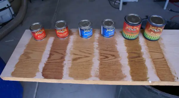 General Finishes stain color chart showing Pecan, Antique Cherry, Americano, Nutmeg, Light Brown, and Pecan wood stain samples on oak.