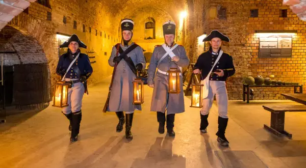 Czterech rekonstruktorów w historycznych strojach wojskowych, niosących latarnie, przemierza ceglane podziemia. To jedne z wielu atrakcji Srebrnej Góry.
