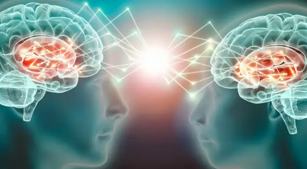 Dwa mózgi połączone siecią neuronów, symbolizujące komunikację i wyrzut dopaminy.