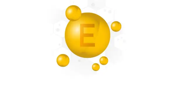 Gocce dorate con la lettera E, simbolo del tocopherol, cos'è e i suoi benefici per la pelle.