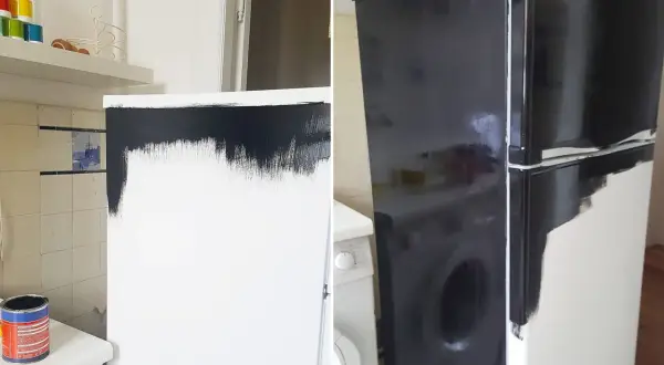 En burk med svart färg står bredvid en tvättmaskin. Kylskåpet är halvmålat i svart, en del av arbetet med att måla kylskåp.