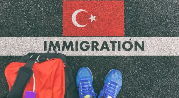 Bagaż i buty na tle flagi Turcji i napisu IMMIGRATION. Czy Turcja jest w Schengen?