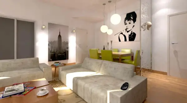 Un moderno soggiorno con un divano davanti alla porta finestra, un quadro di Audrey Hepburn e una vista di New York.