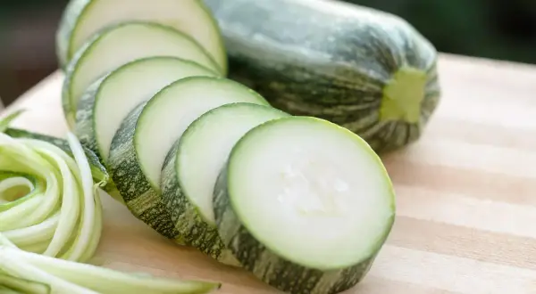Frische Zucchini, in Scheiben geschnitten und zu Spiralen gedreht, bereit, roh gegessen zu werden.