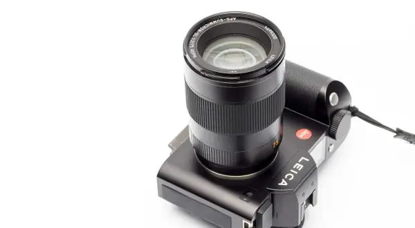 A black Leica camera with a Leica 75mm Summicron lens attached, ready to capture stunning portraits.