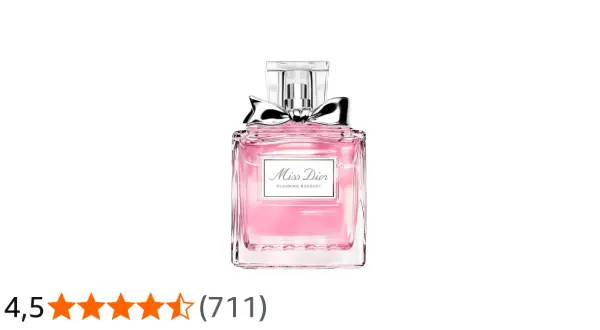 Różowy flakonik perfum Miss Dior Blooming Bouquet z srebrną kokardką, jak kwitnący bukiet wiosennych kwiatów.