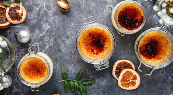 Tre krämiga crème brûlée i glasburkar, med karamelliserad yta. Perfekt för en mysig stund, detta är crème brûlée godaste!