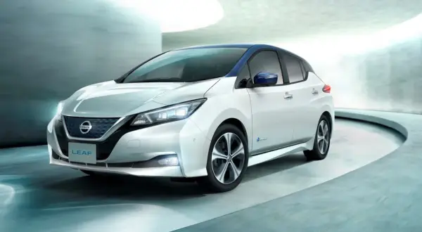 Biały Nissan Leaf z niebieskim dachem, nowoczesny design. Sprawdź nissan leaf cena i odkryj jego zalety.