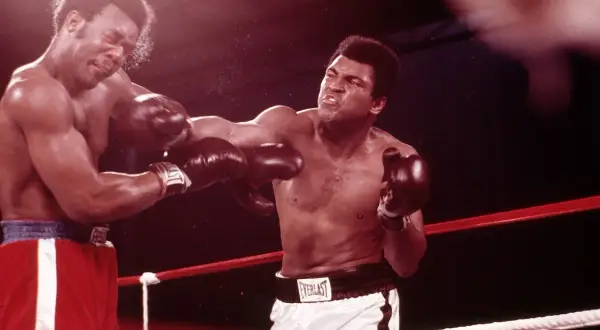 Two boxers in the ring, one landing a punch. The intensity of the fight suggests a close match, perhaps even a unanimous drawing.