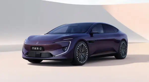 A sleek, dark purple electric sedan with distinctive LED headlights and a modern design.