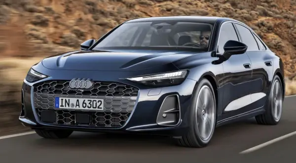 Eleganckie Audi A6 w ciemnym kolorze, jadące po drodze. Sprawdź atrakcyjną audi a6 cena i wybierz swój wymarzony model.