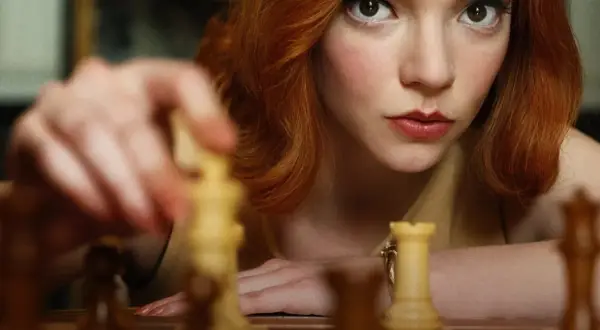 Anya Taylor-Joy jako Beth Harmon w "Gambicie Królowej" przygotowuje ruch na szachownicy.
