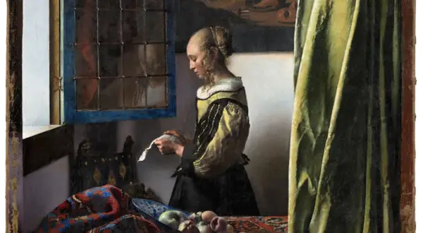 A woman in a yellow and black dress reads a letter by a window, a scene from one of Vermeer's famous paintings of women.