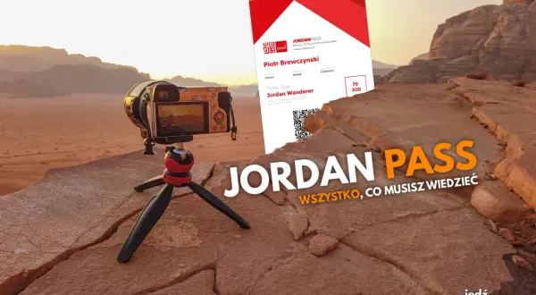 Jordan Pass kosztuje 70 JOD. Aparat na statywie na tle pustyni i karta Jordan Pass.