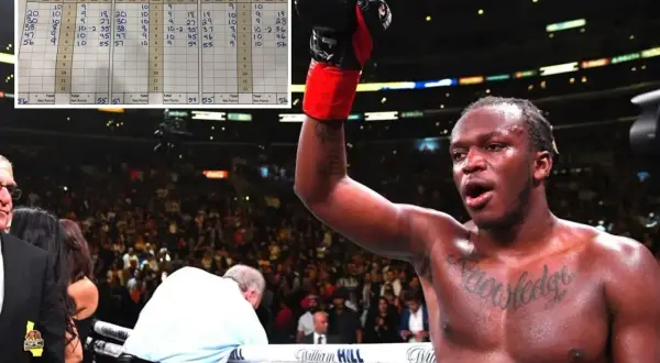 A boxer raises his glove in victory, with a scorecard in the background showing the sd boxing meaning of points awarded in a fight.