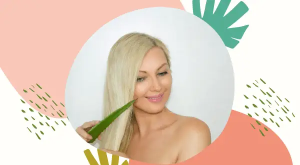Blondynka z uśmiechem dotyka włosów liściem aloesu, który jest naturalnym kosmetykiem, aloes na włosy bez spłukiwania.