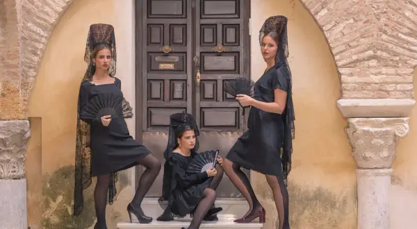 Tres mujeres con mantillas y abanicos negros, listas para bailar. ¡we love flamenco!