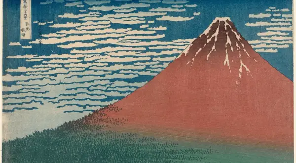 A Katsushika Hokusai artwork depicting Mount Fuji in red, with a forest at its base and a sky filled with swirling clouds.