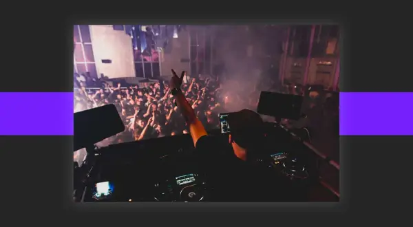 DJ playing to a cheering crowd, a scene that inspires anyone wondering how to get DJ gigs.