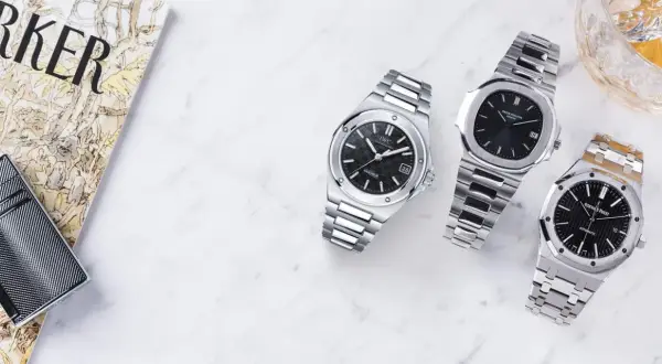Orologi di lusso, tra cui un Patek Philippe Nautilus, ispirato al design di Gérald Genta, accanto a un IWC e un Audemars Piguet.