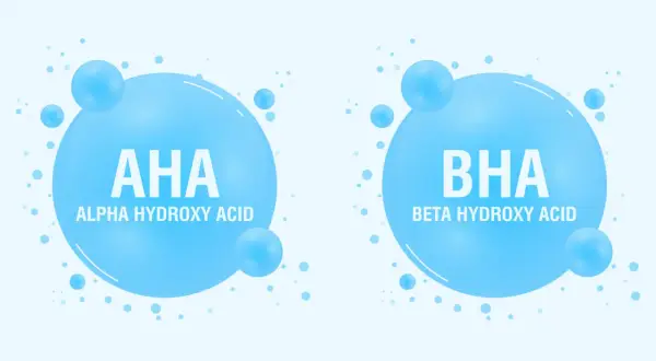 Dwa bąbelki z napisem AHA (Alpha Hydroxy Acid) i BHA (Beta Hydroxy Acid). Kwasy AHA jakie to? To składniki kosmetyków.