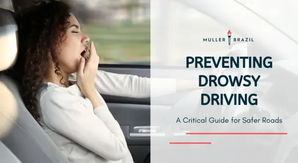 Preventing drowsy driving is crucial, especially for those with conditions like narcolepsy. This image shows a woman yawning while driving, highlighting the dangers.