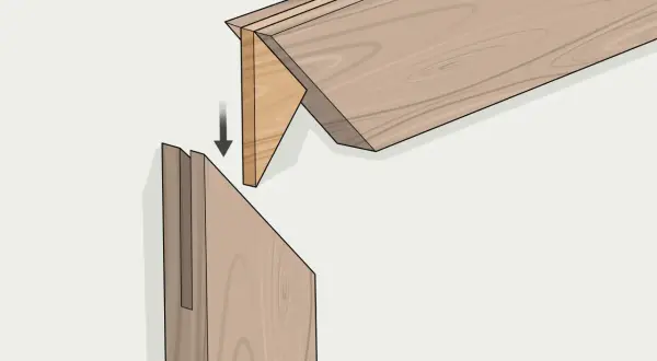 Ensamblaje de madera con un corte a inglete preciso, mostrando cómo encajan las piezas para formar una unión fuerte y limpia.