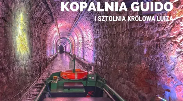 Podziemny spływ w kopalni Guido. Łódź płynie przez oświetlony tunel z kamiennymi ścianami.