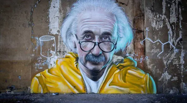 Albert Einstein w żółtej kurtce na tle wzorów chemicznych. Inspiracja, jak nauczyć się chemii.