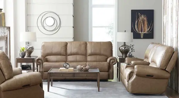 A cozy living room featuring a tan leather sofa and recliners, perfect for a Bassett Furniture identification and value guide.