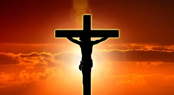 Silhuett av Jesus på korset mot en dramatisk solnedgång. Detta är en stark symbol för vad påsk betyder för många.
