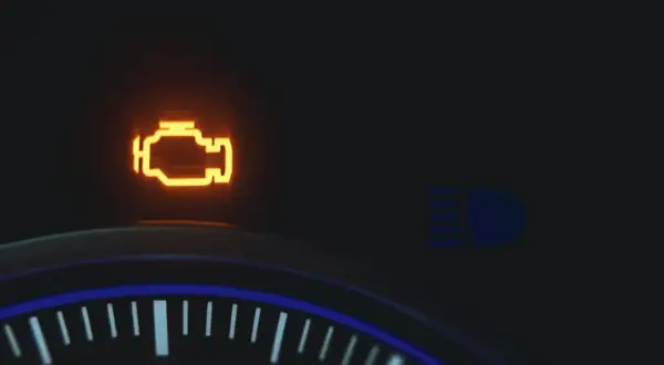Pomarańczowa kontrolka **check engine** świeci na desce rozdzielczej. Obok widać ikonę świateł drogowych.