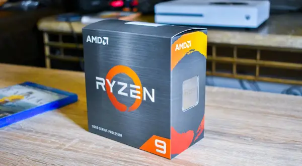 AMD Ryzen 9 5900X Box, bereit für den Test. Daneben liegt ein Blu-ray-Spiel.