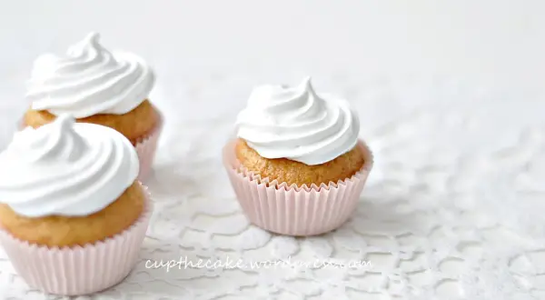 Tre fluffiga muffins med vit frosting, perfekta för ett enkelt frosting recept.