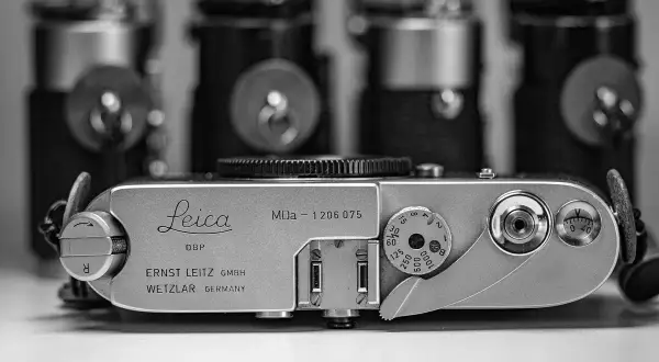 A vintage Leica MDa camera, a classic piece of photographic history, sits in the foreground.